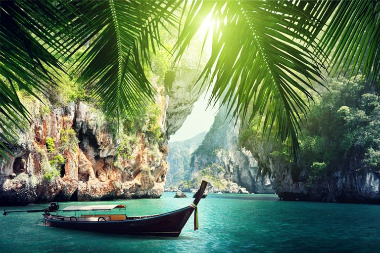 A Long Boat Docked On Beach In Krabi